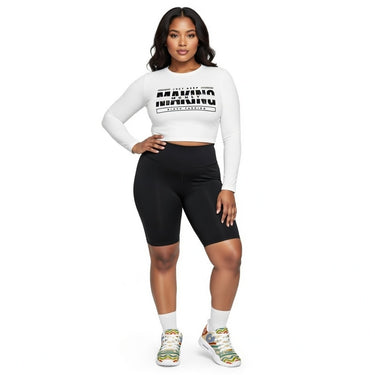 Woman wearing a white long-sleeve crop top with text and black athletic shorts on a white background DGLOX