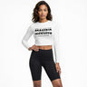 Woman wearing a white long-sleeve crop top with text and black leggings on a white background DGLOX